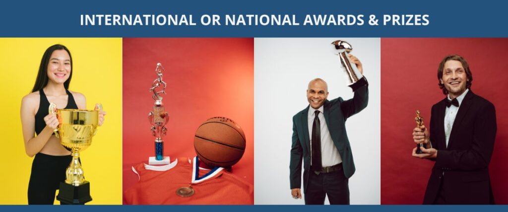 people holding awards, statutes, championship cups
